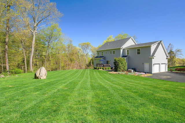 exterior space featuring a garage, driveway, and a deck