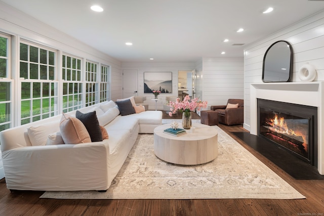 living room with a fireplace with flush hearth, recessed lighting, and wood finished floors