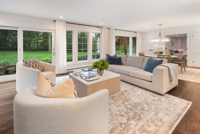 living room featuring a chandelier, wood finished floors, and recessed lighting