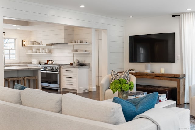 living room with recessed lighting and dark wood-style flooring