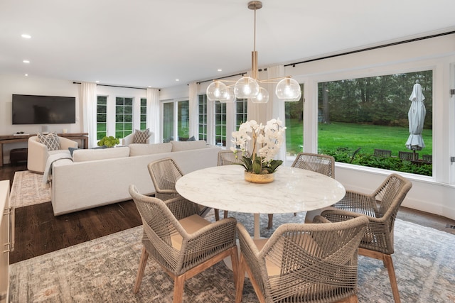 dining space with wood finished floors and recessed lighting