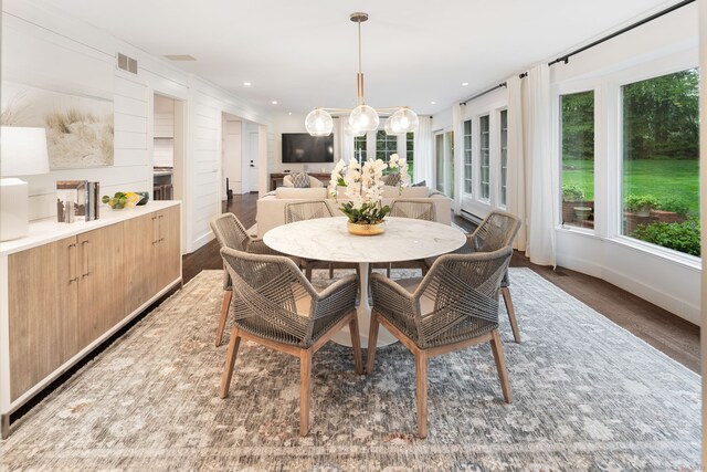 dining room featuring wood finished floors, baseboards, a chandelier, and recessed lighting