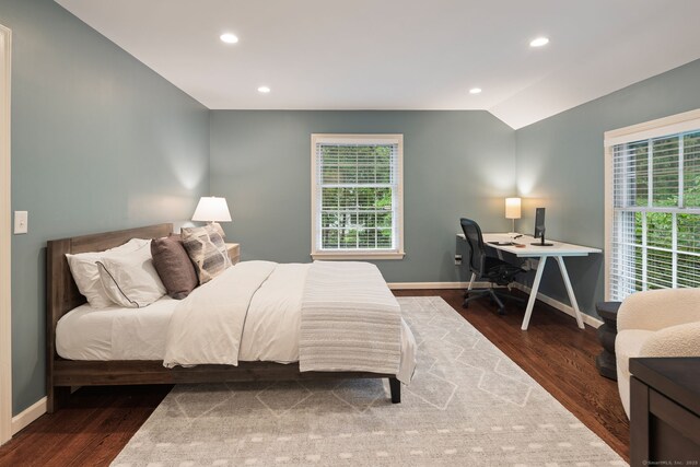 bedroom with baseboards, wood finished floors, an office area, recessed lighting, and lofted ceiling