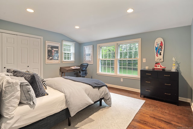 bedroom featuring lofted ceiling, dark wood finished floors, a closet, baseboards, and recessed lighting