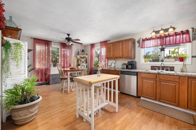 200 Mechanic St, Killingly, CT 06239 - kitchen with dishwasher, a sink, light wood-type flooring, and brown cabinets