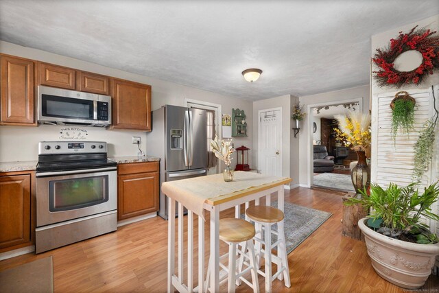 200 Mechanic St, Killingly, CT 06239 - kitchen featuring stainless steel appliances, brown cabinets, and light wood-style flooring