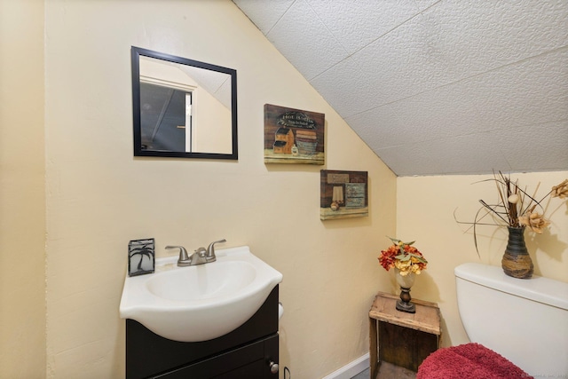 200 Mechanic St, Killingly, CT 06239 - bathroom featuring lofted ceiling, vanity, and toilet
