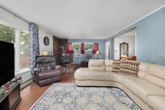 200 Mechanic St, Killingly, CT 06239 - living area featuring a wood stove, wood finished floors, a baseboard radiator, and wooden walls