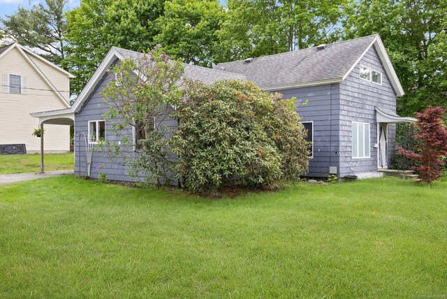 200 Mechanic St, Killingly, CT 06239 - view of front facade featuring a shingled roof, a front lawn, and a carport