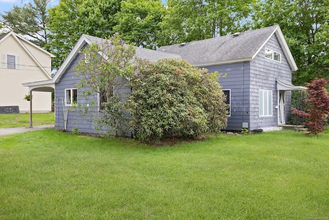 200 Mechanic St, Killingly, CT 06239 - view of side of home featuring a shingled roof, a lawn, and a carport