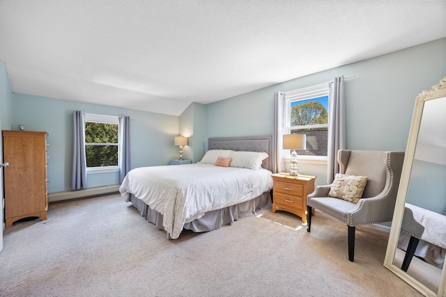carpeted bedroom featuring a baseboard heating unit