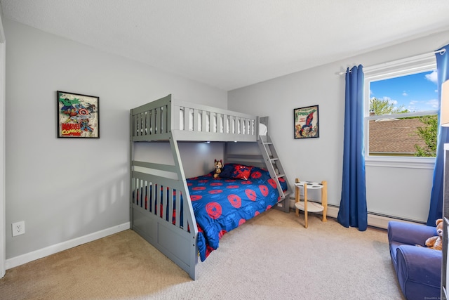 bedroom featuring carpet floors, baseboards, and a baseboard heating unit