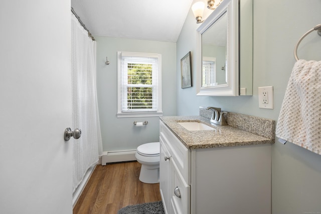 full bathroom with a baseboard heating unit, wood finished floors, vanity, toilet, and baseboards