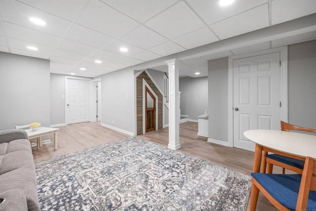 living area featuring wood finished floors, stairway, baseboards, and recessed lighting