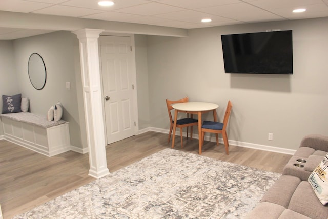living room with wood finished floors, baseboards, and recessed lighting