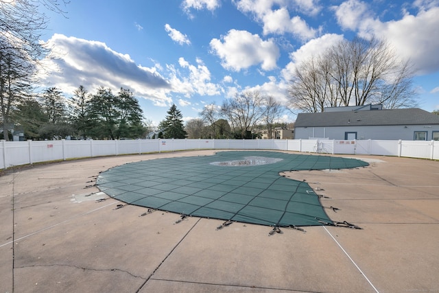 pool featuring a patio and fence