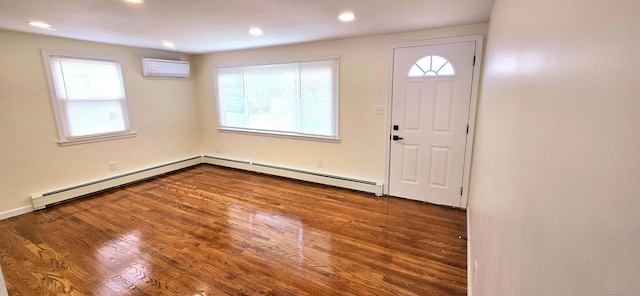 foyer featuring a baseboard heating unit, recessed lighting, a wall mounted air conditioner, and wood finished floors