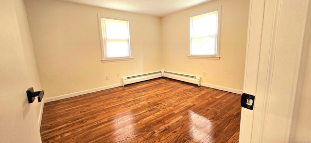 spare room featuring baseboards, wood finished floors, and baseboard heating