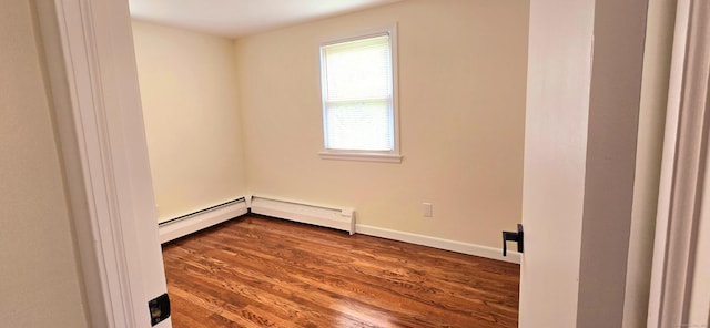 empty room with baseboards, a baseboard heating unit, and dark wood-type flooring