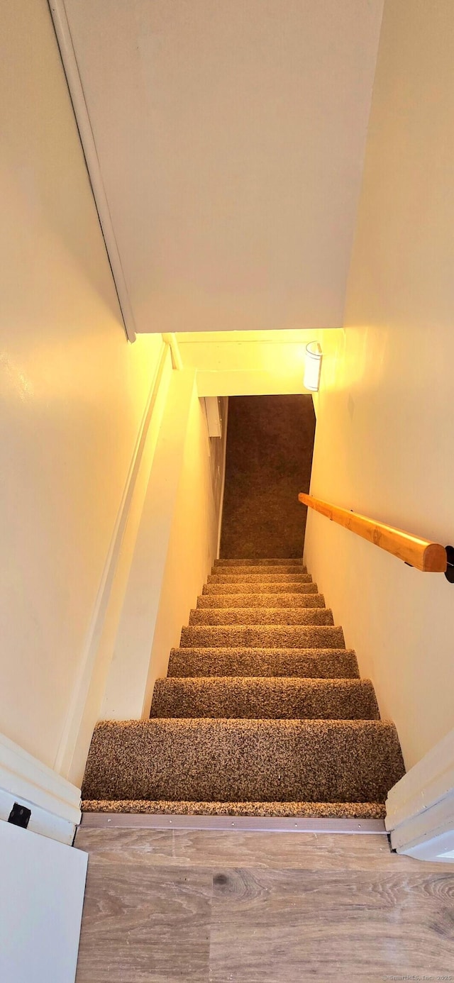 stairs with wood finished floors