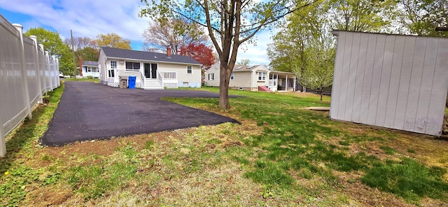back of property with a yard and entry steps