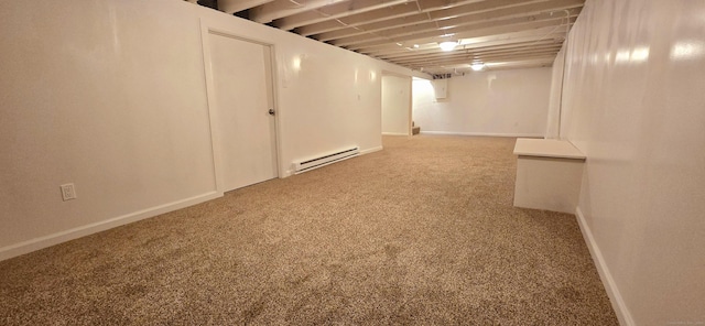 finished basement featuring carpet floors, baseboards, and a baseboard radiator