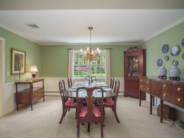 dining area with a chandelier, light colored carpet, crown molding, baseboard heating, and a wainscoted wall