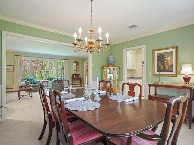 dining room with ornamental molding, a chandelier, and light colored carpet