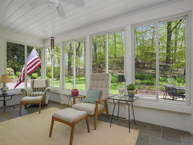 sunroom / solarium featuring stone tile flooring