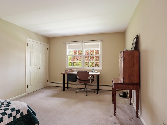 carpeted bedroom with a baseboard radiator, baseboards, a closet, and a desk