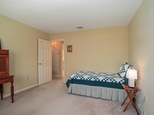 bedroom featuring carpet and baseboards