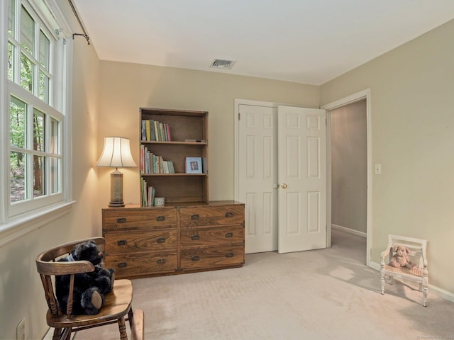 living area featuring carpet and baseboards