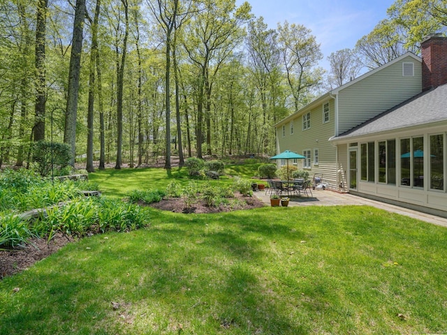 view of grassy yard featuring a patio area