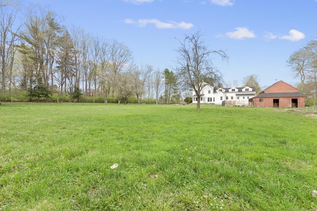 view of yard with an outdoor structure and a barn