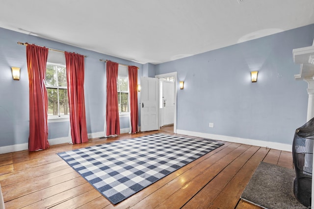 interior space with baseboards and light wood finished floors