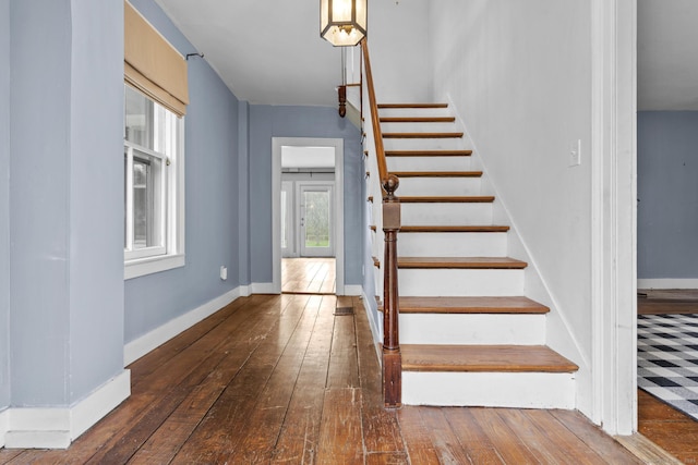 stairs with baseboards and hardwood / wood-style flooring