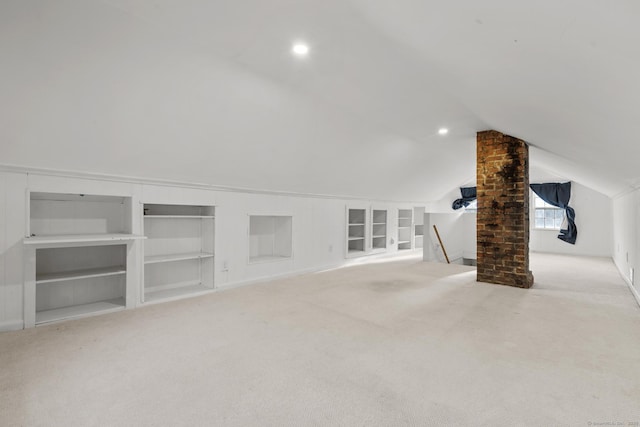 bonus room featuring built in features, vaulted ceiling, and carpet floors