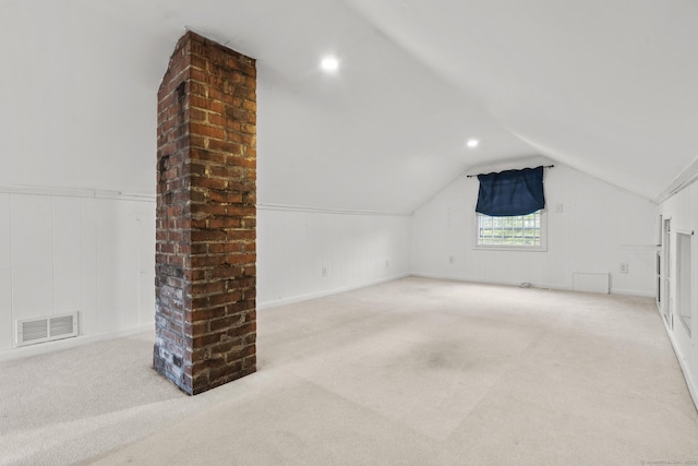 bonus room with carpet floors, visible vents, vaulted ceiling, and a decorative wall
