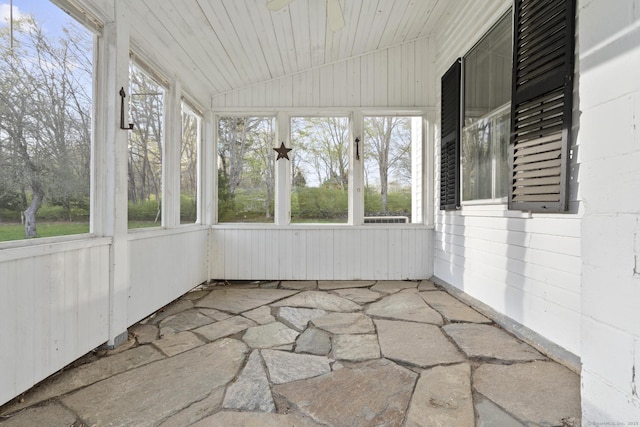 unfurnished sunroom with plenty of natural light and ceiling fan