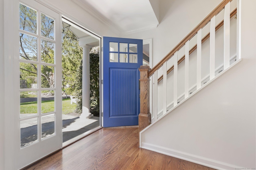 entryway featuring crown molding and wood finished floors