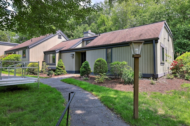 951 Heritage Vlg Unit B, Southbury, CT 06488 - view of front of property featuring a shingled roof, a chimney, and a deck