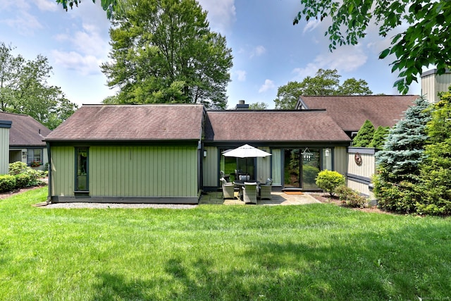 951 Heritage Vlg Unit B, Southbury, CT 06488 - rear view of house with a chimney, a yard, roof with shingles, and a patio area