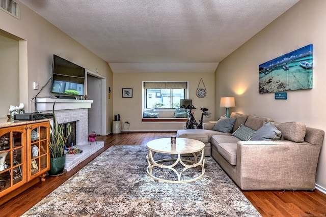 951 Heritage Vlg Unit B, Southbury, CT 06488 - living room with wood finished floors, a fireplace, and a textured ceiling