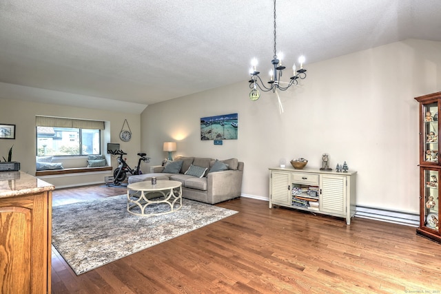 951 Heritage Vlg Unit B, Southbury, CT 06488 - living area with baseboard heating, wood finished floors, a chandelier, vaulted ceiling, and a textured ceiling
