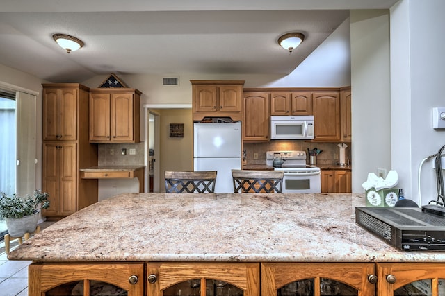 951 Heritage Vlg Unit B, Southbury, CT 06488 - kitchen with white appliances, tasteful backsplash, light stone counters, and brown cabinets