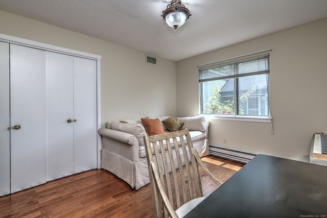 951 Heritage Vlg Unit B, Southbury, CT 06488 - bedroom with a baseboard radiator, wood finished floors, and a closet