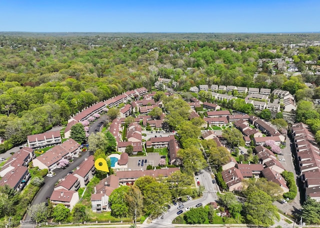 drone / aerial view with a forest view and a residential view