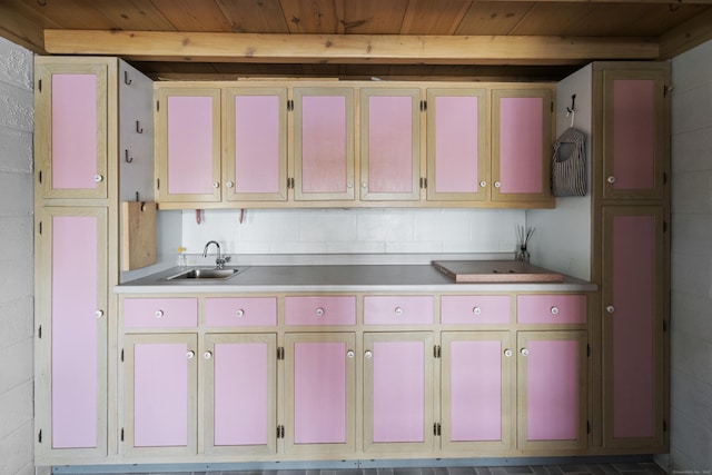 kitchen featuring a sink, light countertops, and wooden ceiling