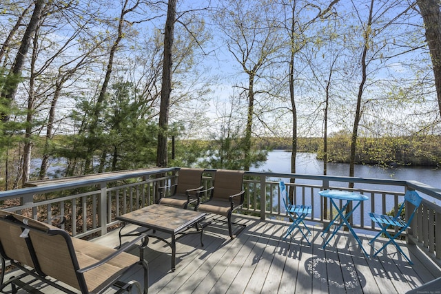 wooden terrace featuring a water view
