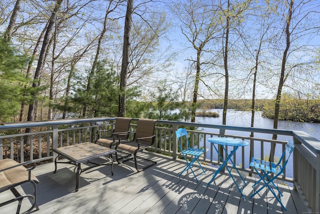 wooden terrace featuring a water view